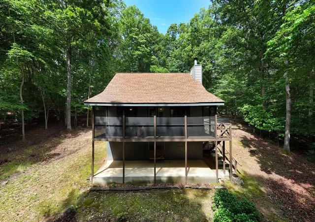 a view of a wooden house with a yard