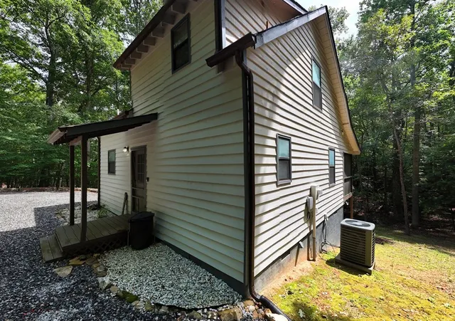 a view of a small house with a yard