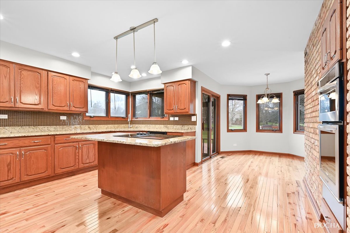 9638 Book Road Naperville, IL 60564 - Photo 14 of 44 a large kitchen with stainless steel appliances granite countertop a stove and cabinets