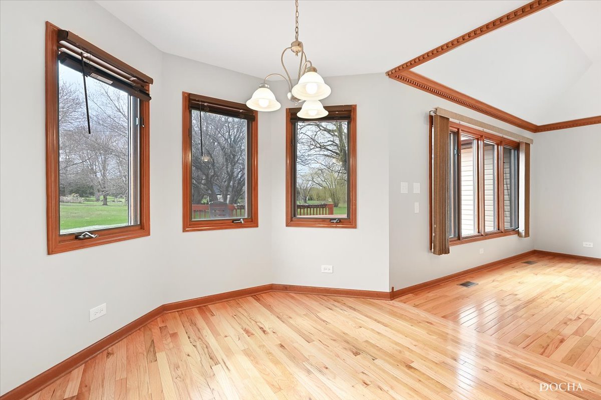 9638 Book Road Naperville, IL 60564 - Photo 16 of 44 a view of an empty room with a window and wooden floor