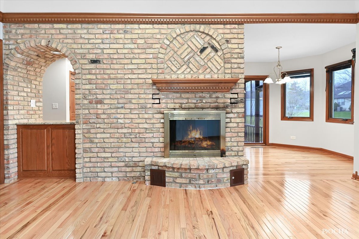 9638 Book Road Naperville, IL 60564 - Photo 17 of 44 a living room with a wooden floor and a fireplace