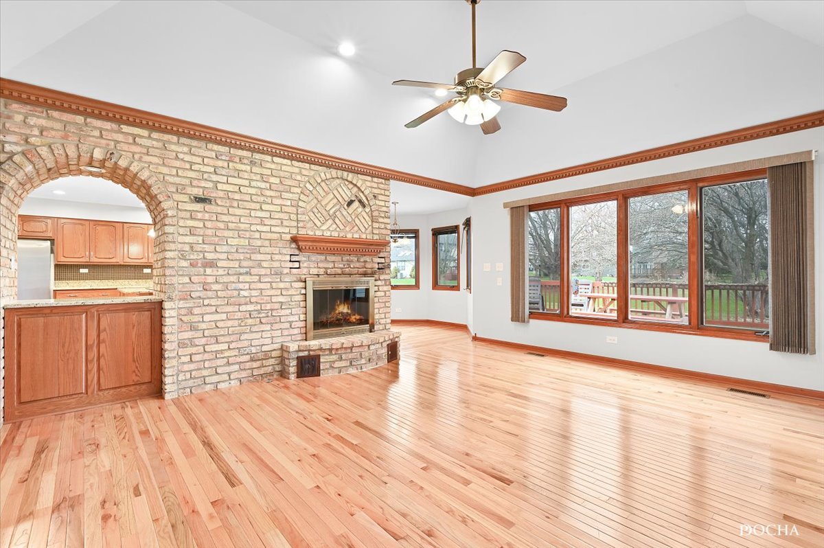 9638 Book Road Naperville, IL 60564 - Photo 18 of 44 a view of an empty room with a fireplace and wooden floor