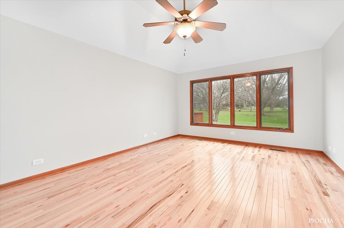 9638 Book Road Naperville, IL 60564 - Photo 21 of 44 a view of an empty room with wooden floor and a window