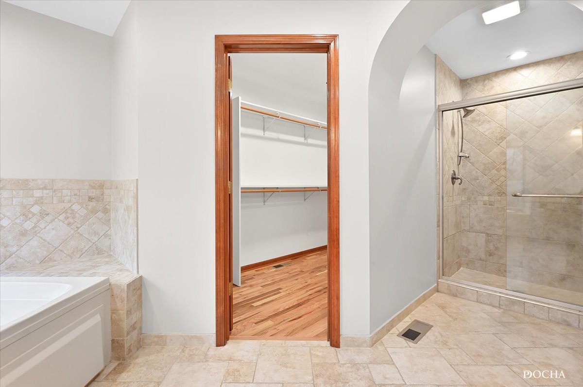 9638 Book Road Naperville, IL 60564 - Photo 26 of 44 a bathroom with a bathtub and shower