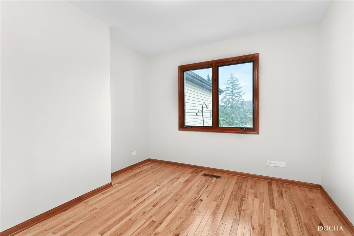 9638 Book Road Naperville, IL 60564 - Photo 28 of 44 an empty room with wooden floor and windows