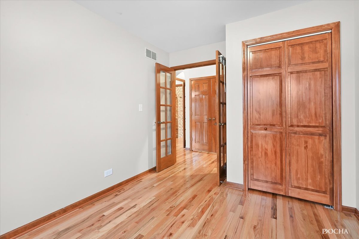 9638 Book Road Naperville, IL 60564 - Photo 29 of 44 an empty room with wooden floor and closet area