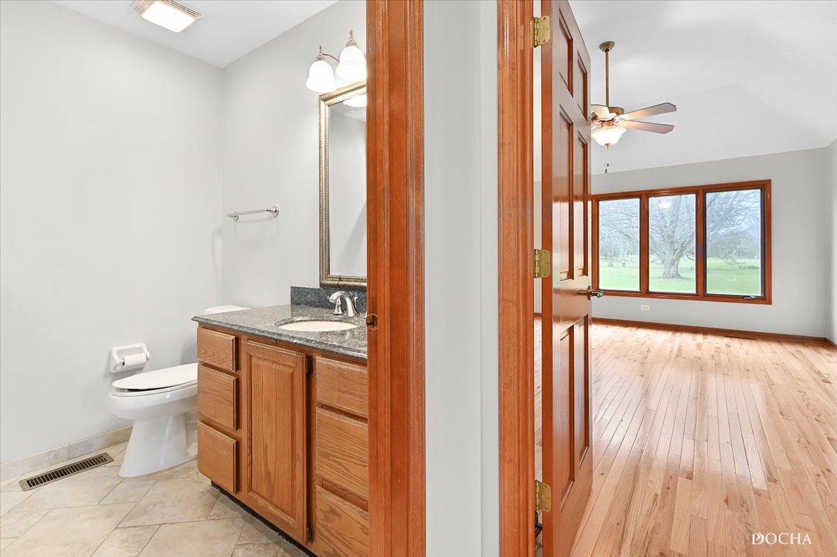 9638 Book Road Naperville, IL 60564 - Photo 31 of 44 a bathroom with a granite countertop sink toilet and shower curtains