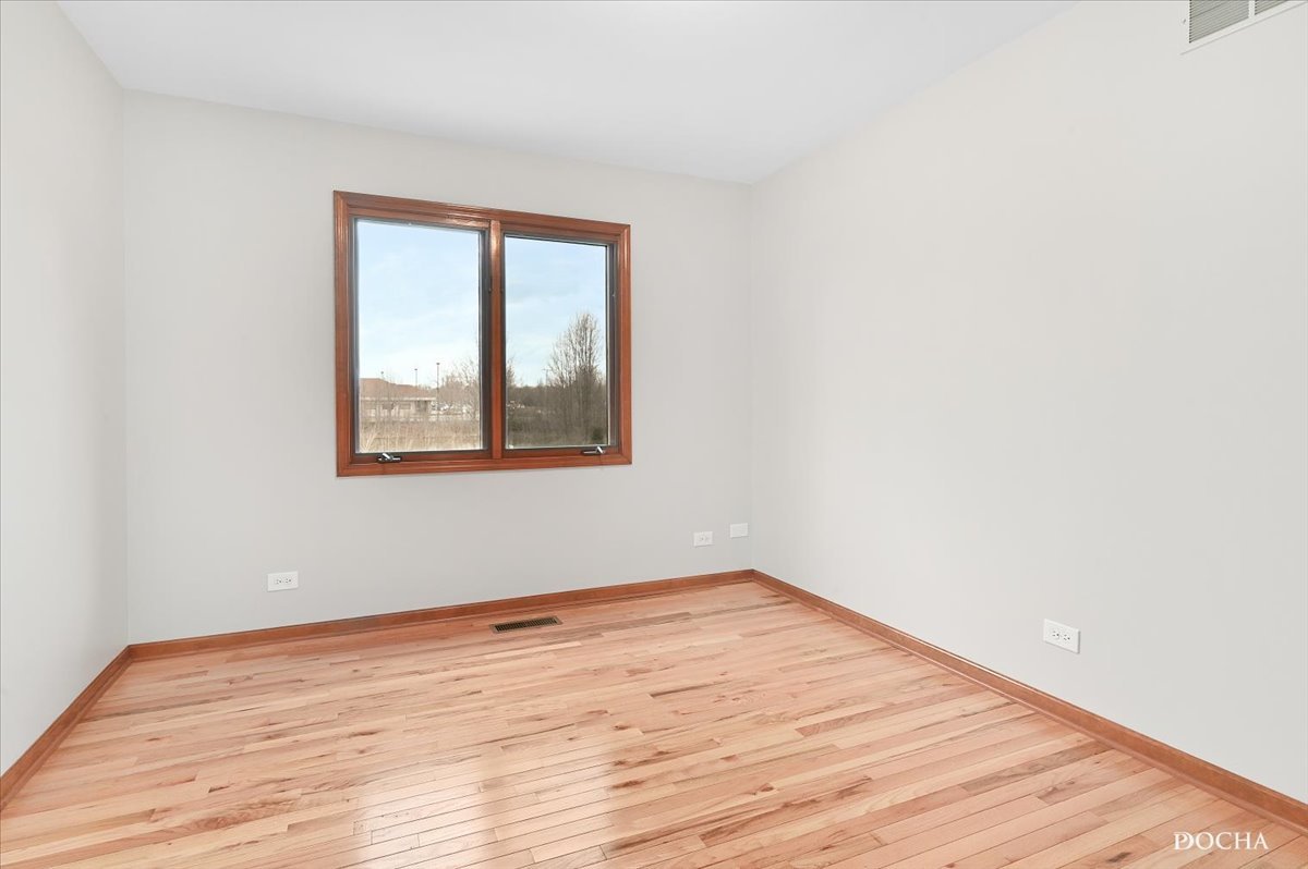 9638 Book Road Naperville, IL 60564 - Photo 34 of 44 an empty room with wooden floor and windows