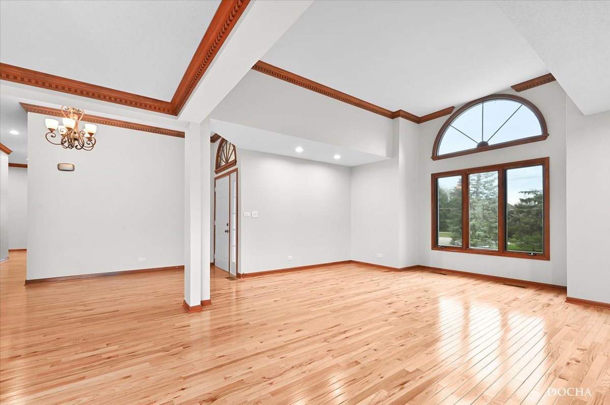 9638 Book Road Naperville, IL 60564 - Photo 4 of 44 a view of an empty room with wooden floor and a window