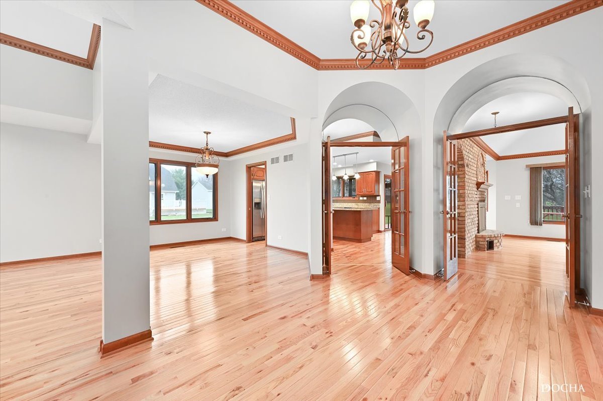 9638 Book Road Naperville, IL 60564 - Photo 5 of 44 a view of a hallway with wooden floor and chandelier