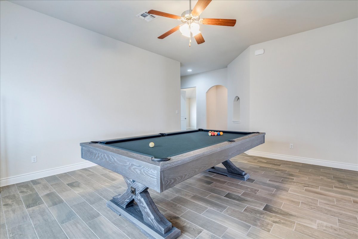 124 Compass Lane Kyle, TX 78640 - Photo 6 of 38 a room with pool table chandelier fan and wooden floor