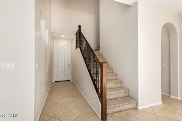 a view of staircase with white walls and railing