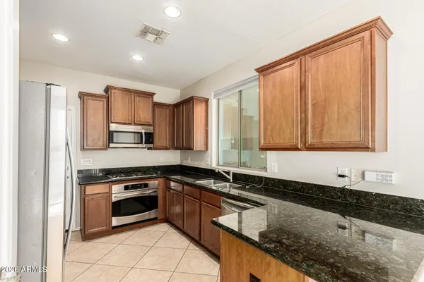 a kitchen with stainless steel appliances a stove a microwave and a refrigerator
