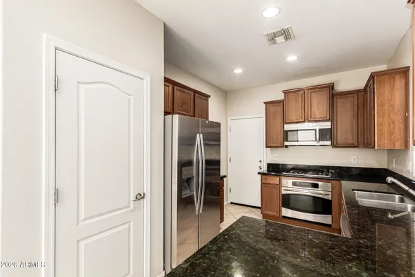 a view of kitchen with granite countertop cabinets and sink