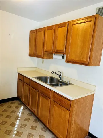 a kitchen with a sink a stove and cabinets