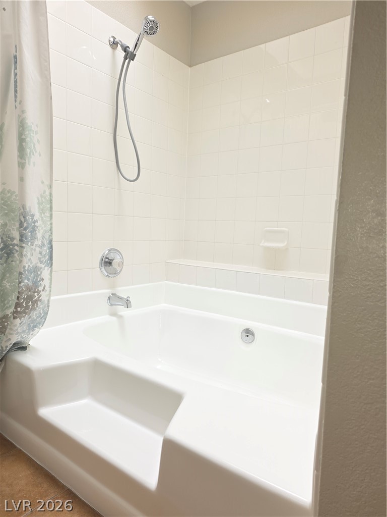 9325 West Desert Inn Road, Unit 239 Las Vegas, NV 89117 - Photo 20 of 29 Full bath featuring shower / bathtub combination with curtain and tile patterned floors