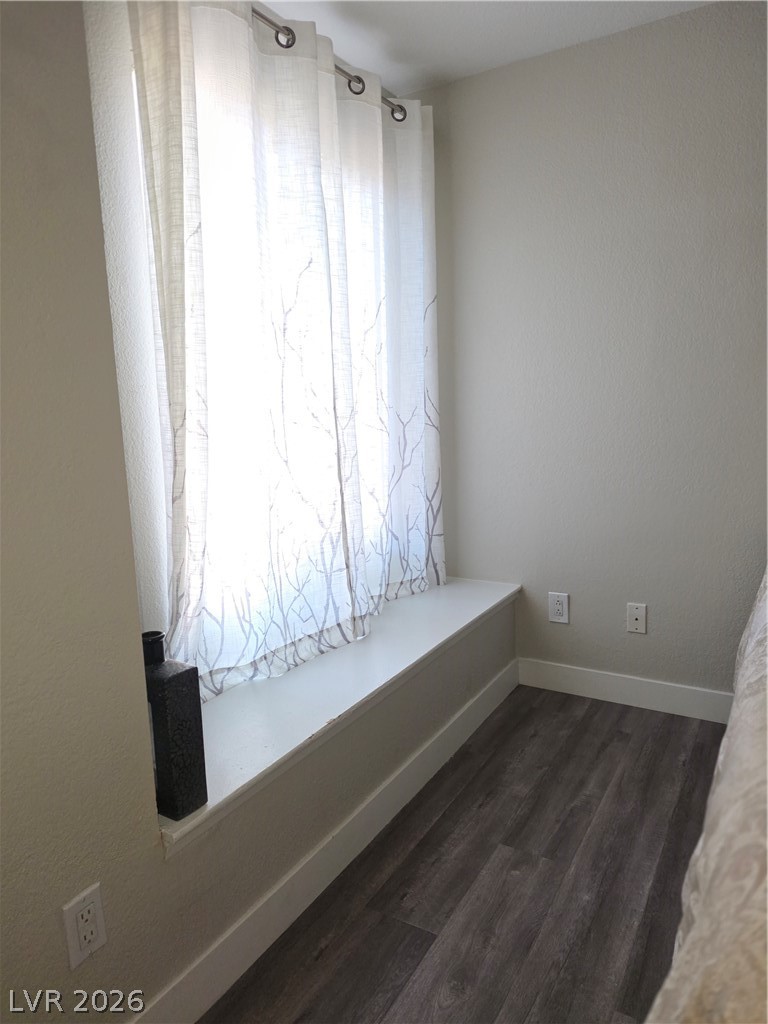 9325 West Desert Inn Road, Unit 239 Las Vegas, NV 89117 - Photo 22 of 29 Unfurnished room with baseboards and dark wood-style flooring