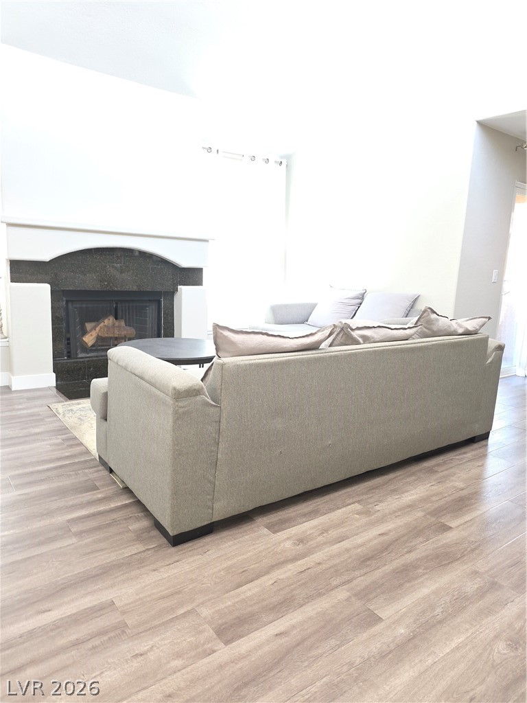 9325 West Desert Inn Road, Unit 239 Las Vegas, NV 89117 - Photo 4 of 29 Living area featuring light wood-style flooring and a fireplace