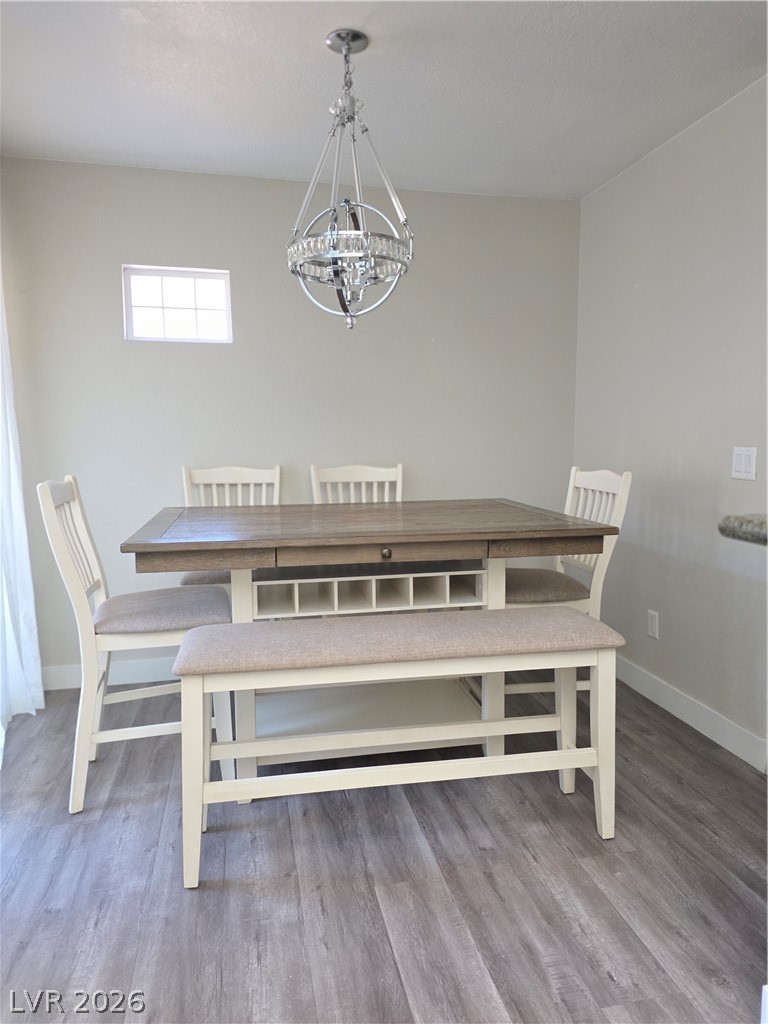 9325 West Desert Inn Road, Unit 239 Las Vegas, NV 89117 - Photo 8 of 29 Dining space with suspended lighting and light wood-style floors