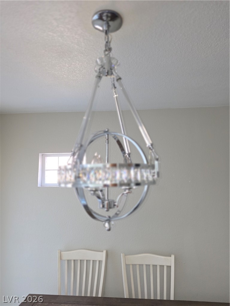 9325 West Desert Inn Road, Unit 239 Las Vegas, NV 89117 - Photo 9 of 29 Dining area view of hanging lights and a textured ceiling
