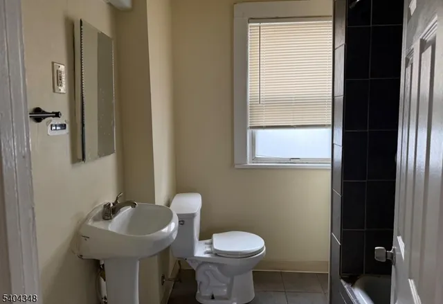 a bathroom with a sink toilet and a mirror