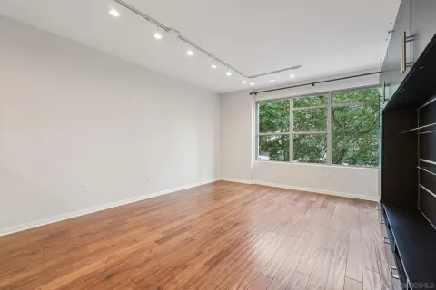 wooden floor in an empty room with a window