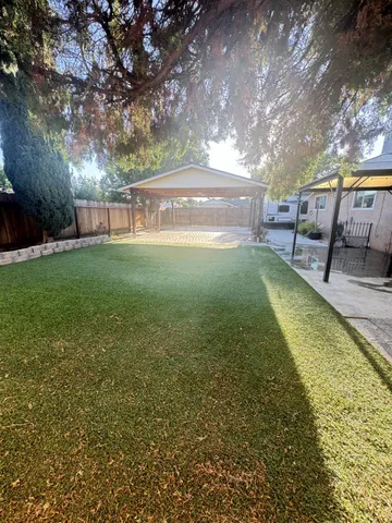 a view of yard with swimming pool and sitting area