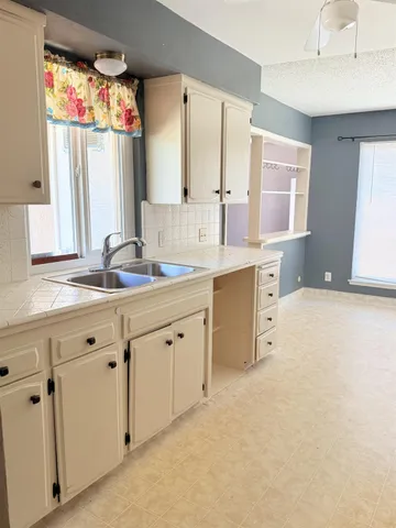 a spacious bathroom with a granite countertop sink mirror and a