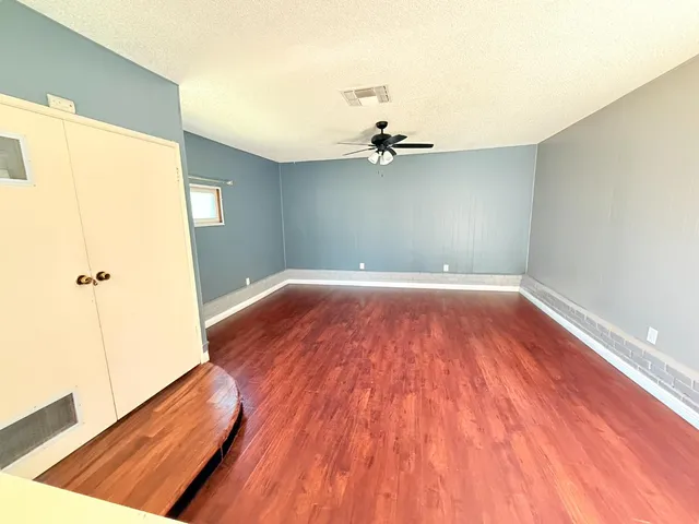 a view of a room with a wooden floor