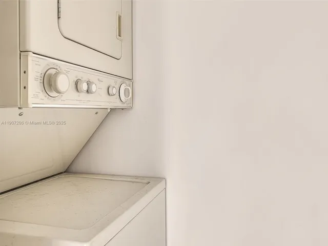 a kitchen with kitchen island granite countertop a sink stove and cabinets