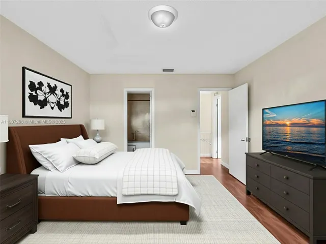 a view of a room with wooden floor and white walls