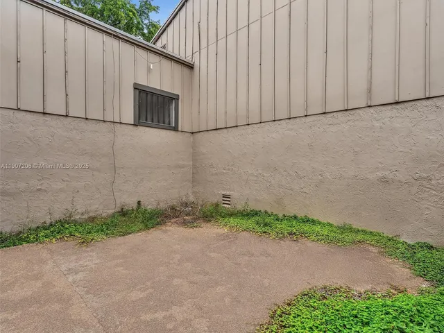a view of a wooden door in front of a house