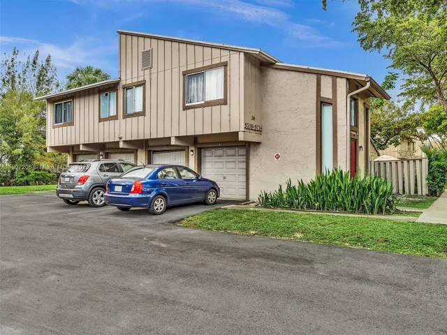 an aerial view of a house with garden space and trees