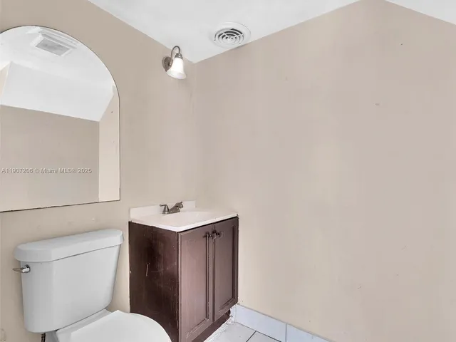 a bathroom with a sink mirror and toilet