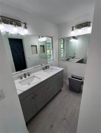 a bathroom with a double vanity sink and mirror