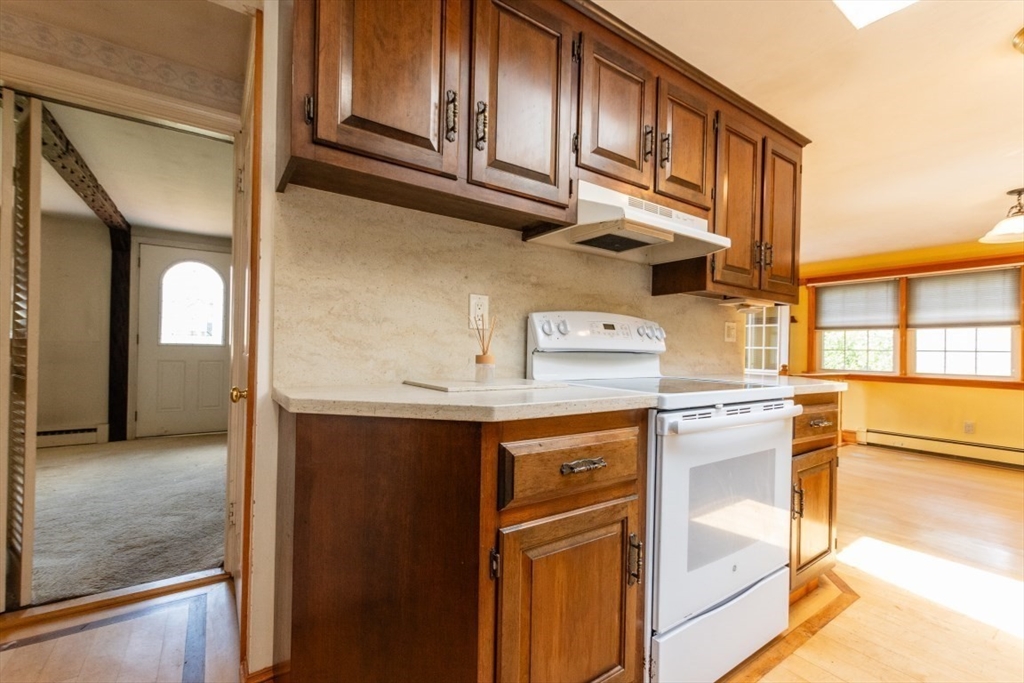 249 Main Street Walpole, MA 02081 - Photo 11 of 31 a view of a kitchen with stainless steel appliances granite countertop a refrigerator and a sink