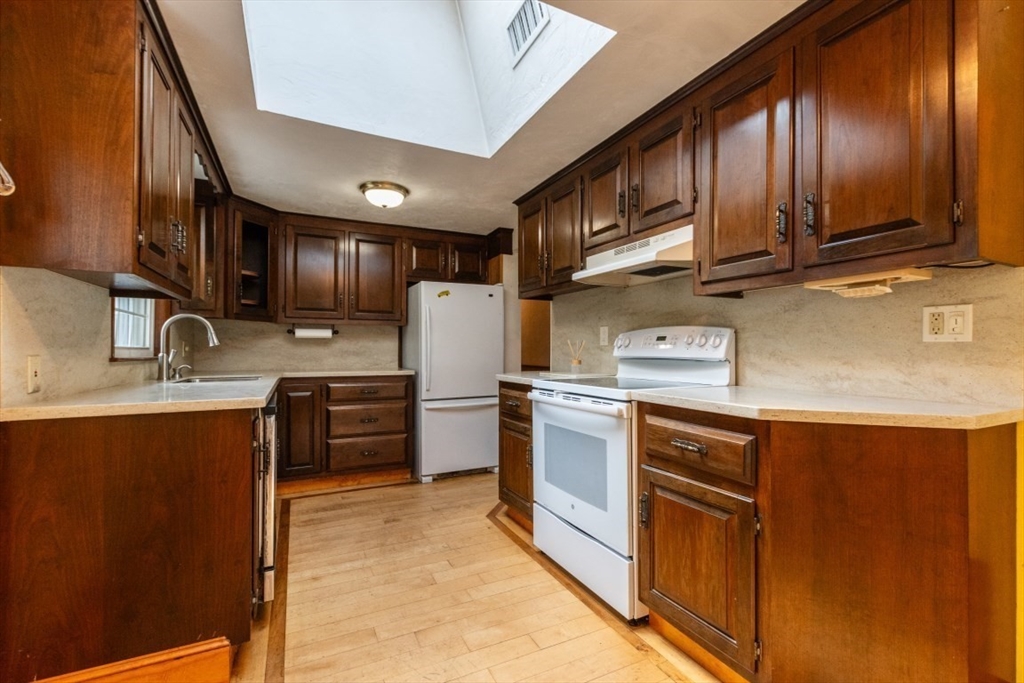 249 Main Street Walpole, MA 02081 - Photo 12 of 31 a kitchen with stainless steel appliances granite countertop a sink stove and refrigerator