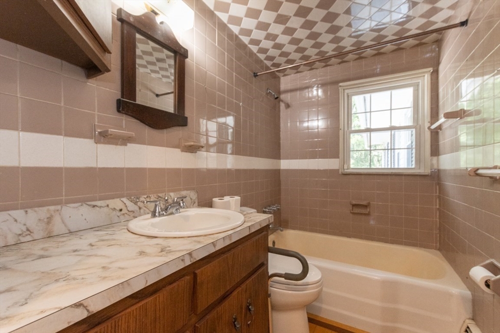 249 Main Street Walpole, MA 02081 - Photo 19 of 31 a bathroom with a sink a toilet and bathtub