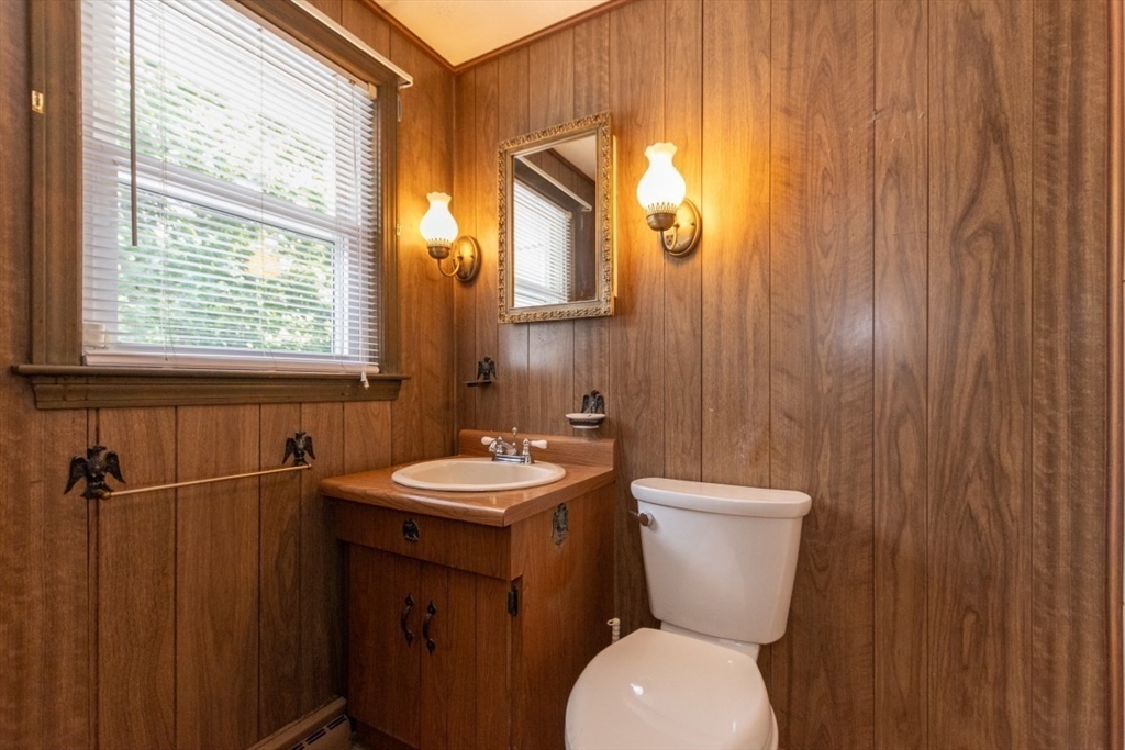 249 Main Street Walpole, MA 02081 - Photo 20 of 31 a bathroom with a toilet a sink and mirror