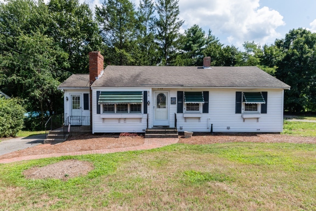 249 Main Street Walpole, MA 02081 - Photo 2 of 31 a front view of a house with a garden and yard