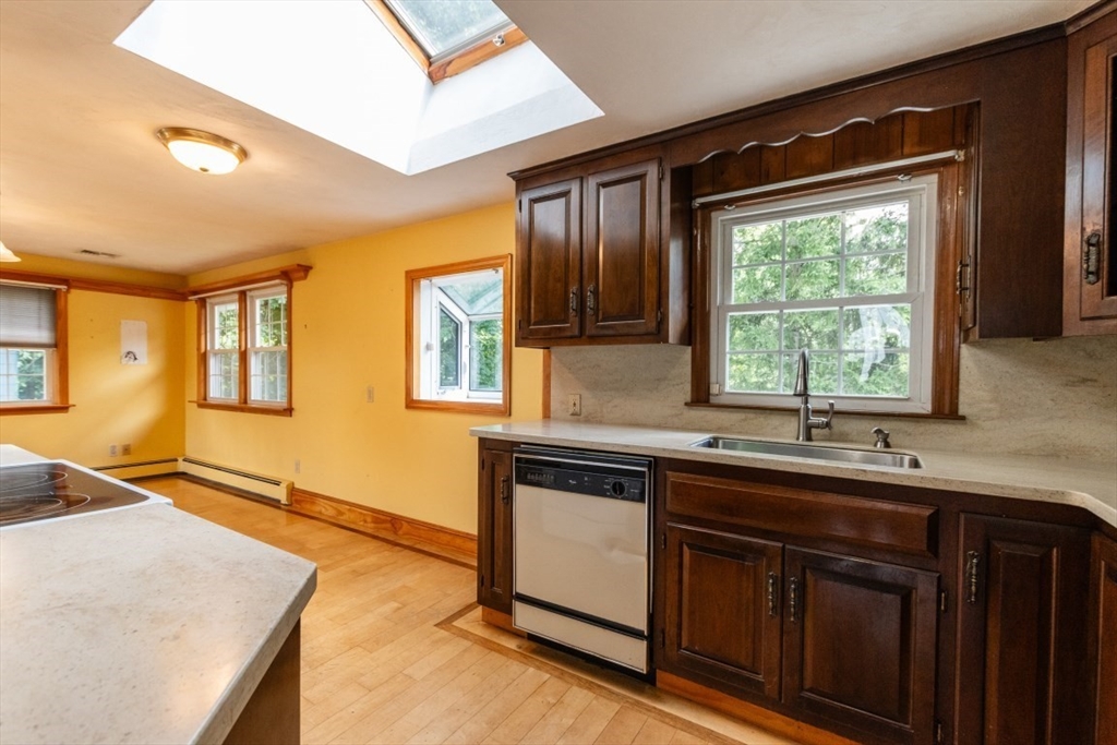249 Main Street Walpole, MA 02081 - Photo 10 of 31 a kitchen with a sink stove and cabinets