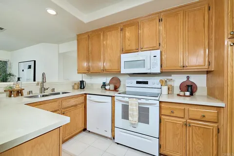 a kitchen with stainless steel appliances granite countertop a sink and cabinets