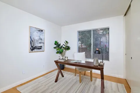 a workspace room with furniture and wooden floor