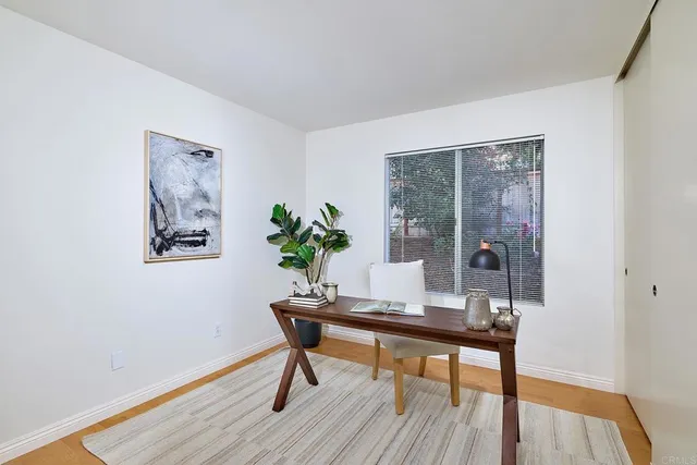 a workspace room with furniture and wooden floor