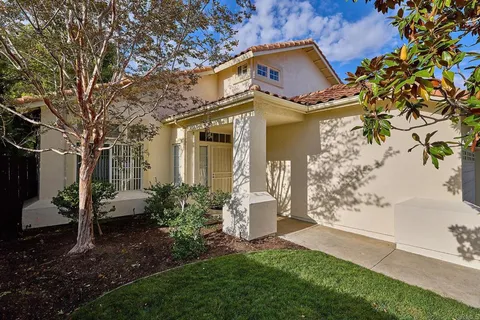 a front view of a house with garden