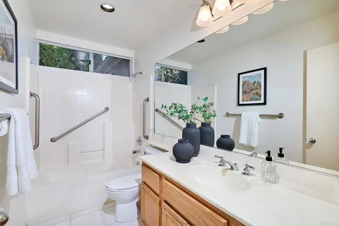 a bathroom with a sink a toilet and shower curtain