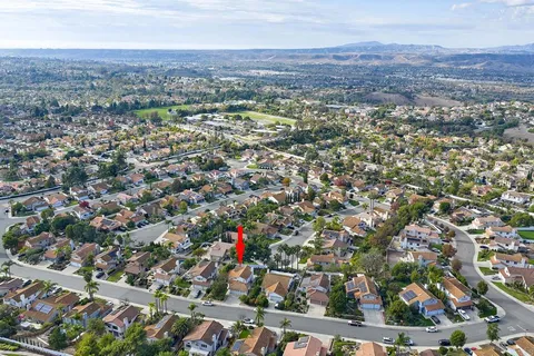 an aerial view of residential houses with city view