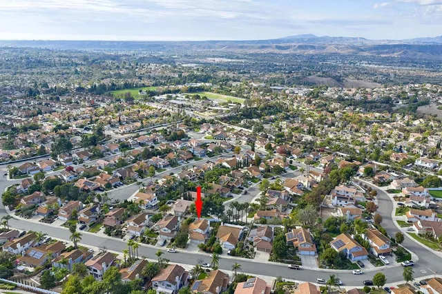 an aerial view of residential houses with city view
