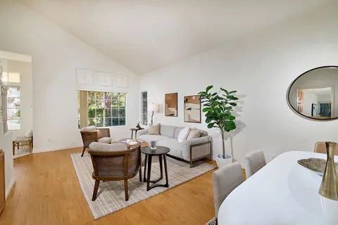 a living room with furniture and a potted plant