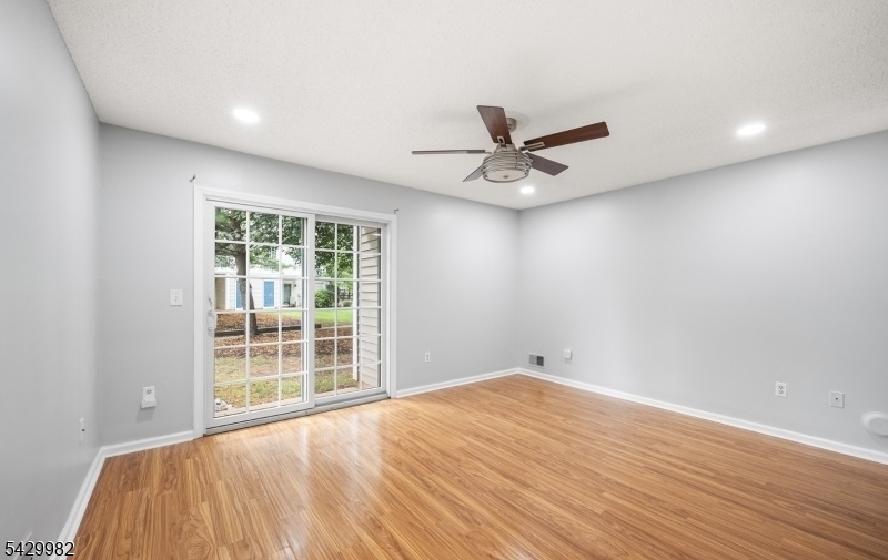 3702 Riddle Court, Unit 2 Bridgewater, NJ 08807 - Photo 13 of 20 a view of a big room with wooden floor and a chandelier fan